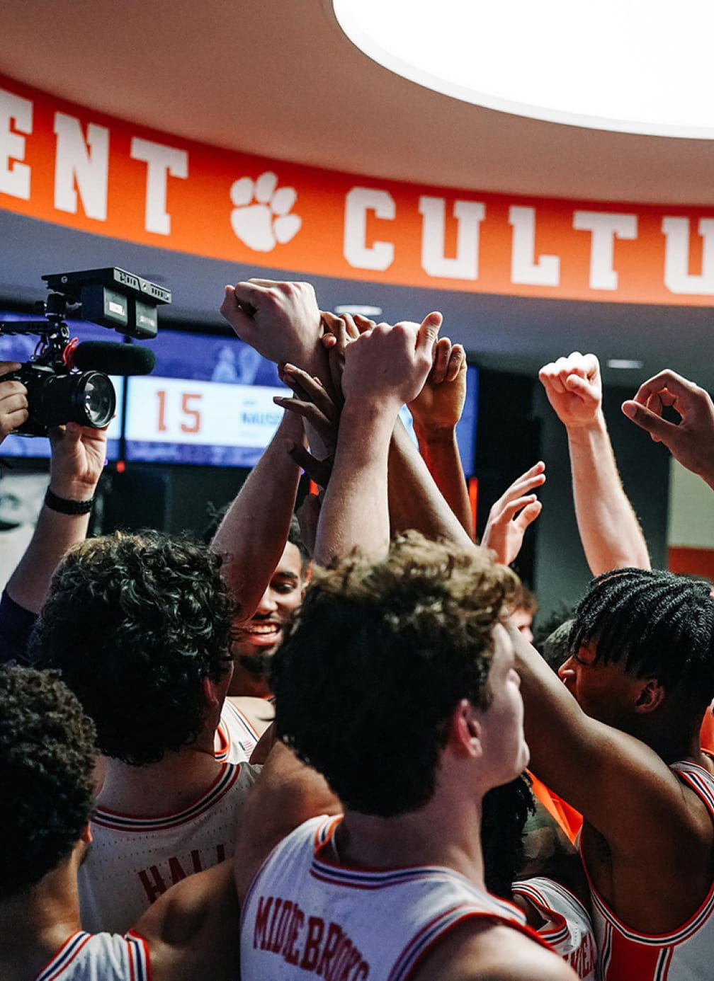 Clemson basketball team huddled in the locker room 