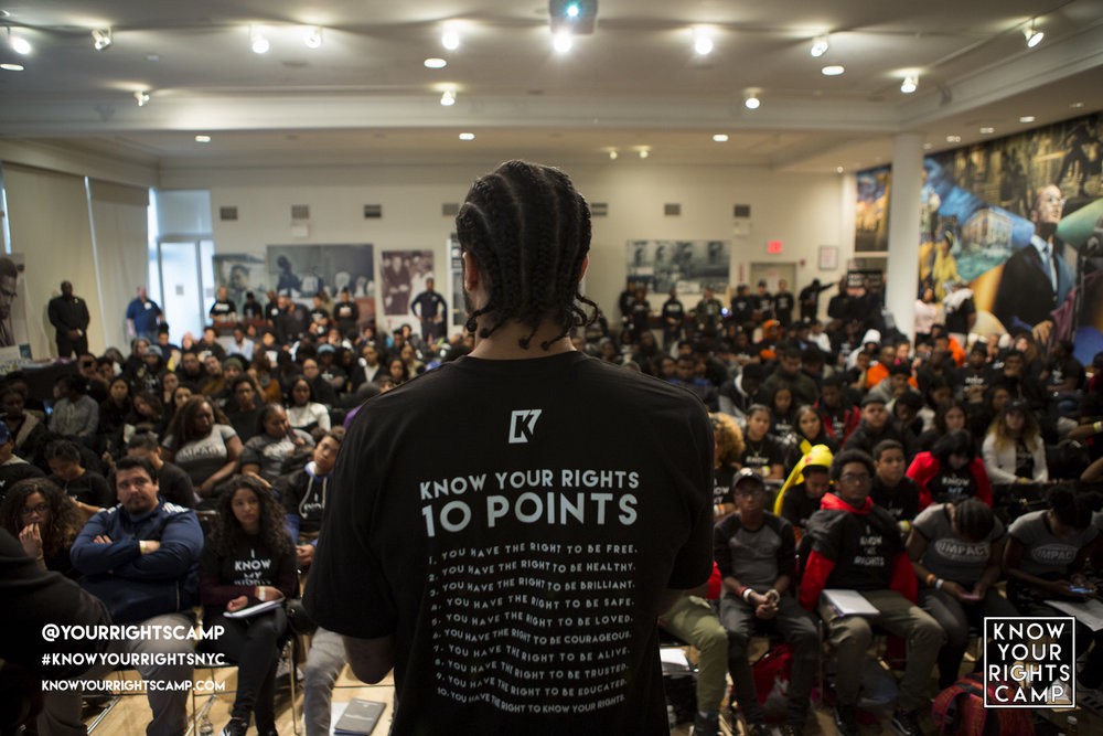 Colin Kaepernick speaking to at-risk youth at his Know Your Rights Camp in New York City. Image via www.knowyourrightscamp.com