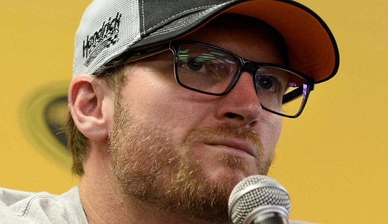 Dale Earnhardt Jr. speaks to the media with an update regarding his progress from a concussion injury (September 2016). Image from The Inquisitr
