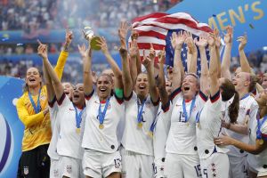 Jul 7, 2019; Lyon, FRANCE; United States forward Alex Morgan (13) hoists the World Cup trophy and celebrates with teammates after defeating the Netherlands in the championship match of the FIFA Women's World Cup France 2019 at Stade de Lyon.