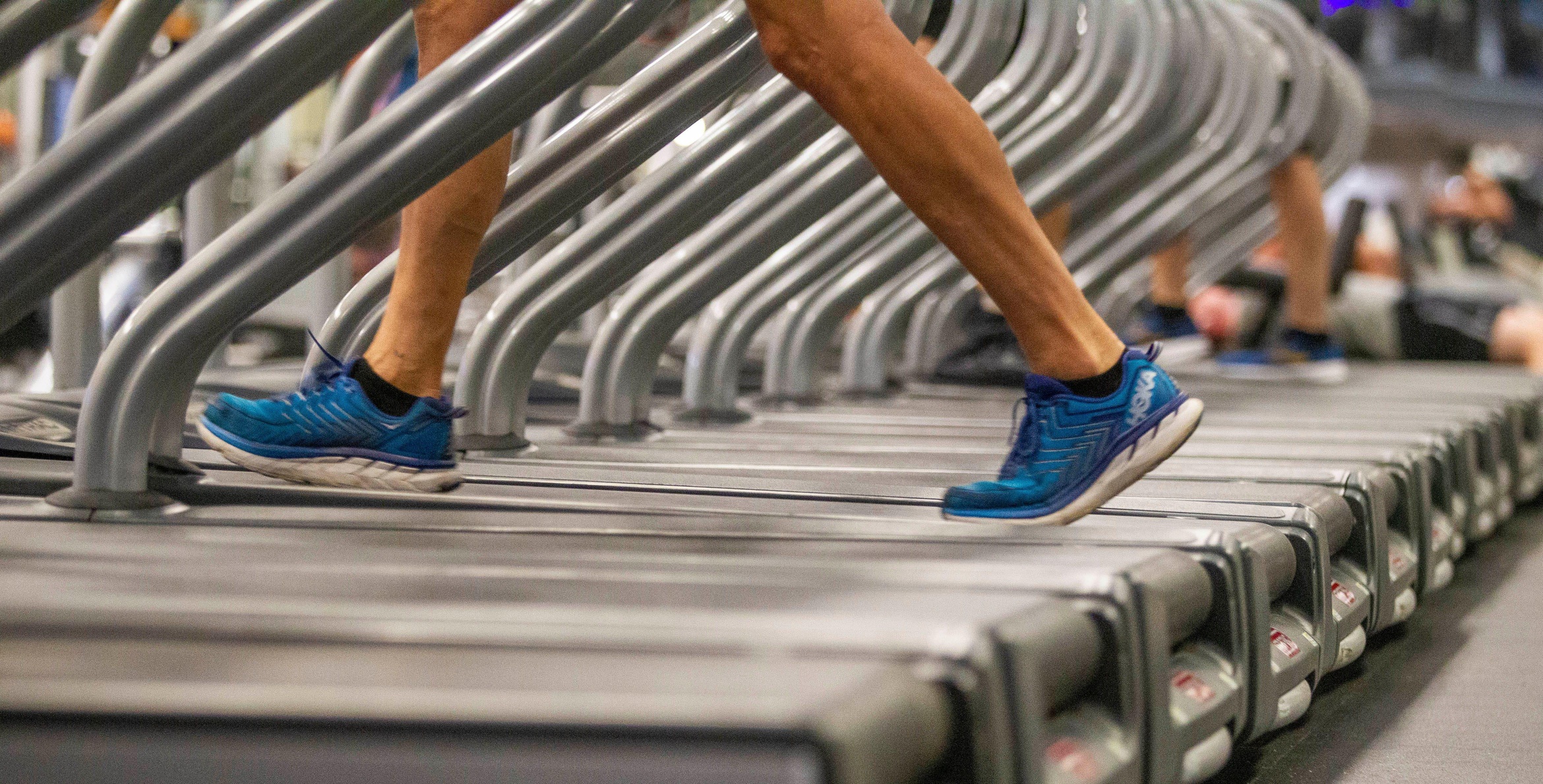 A detail view of someone walking on a treadmill.