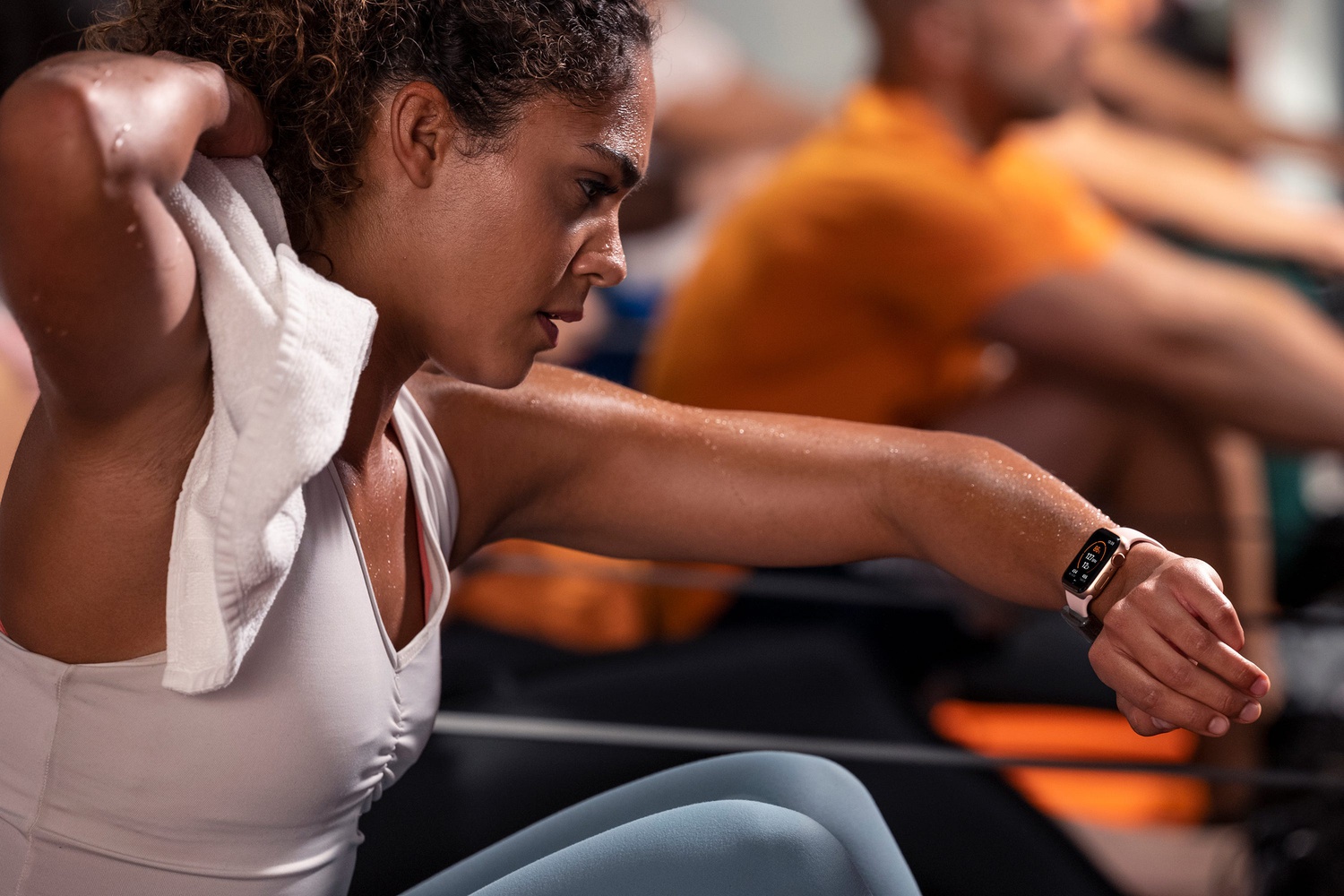 a woman works out and checks her Apple Watch