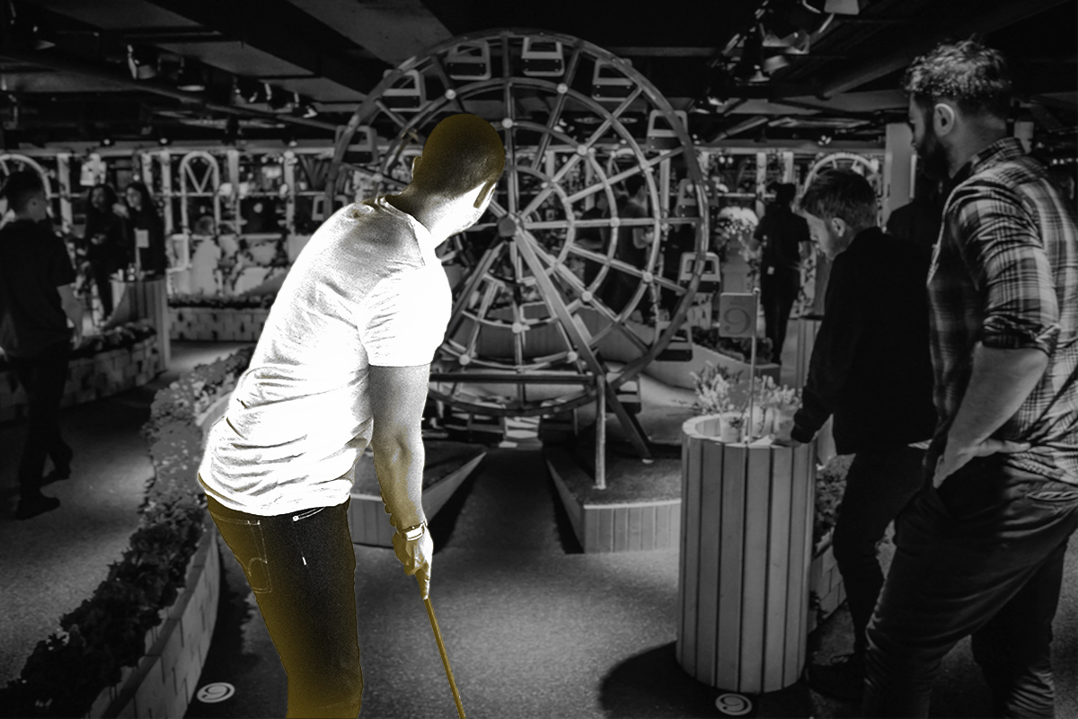 three_men_playing_mini_golf