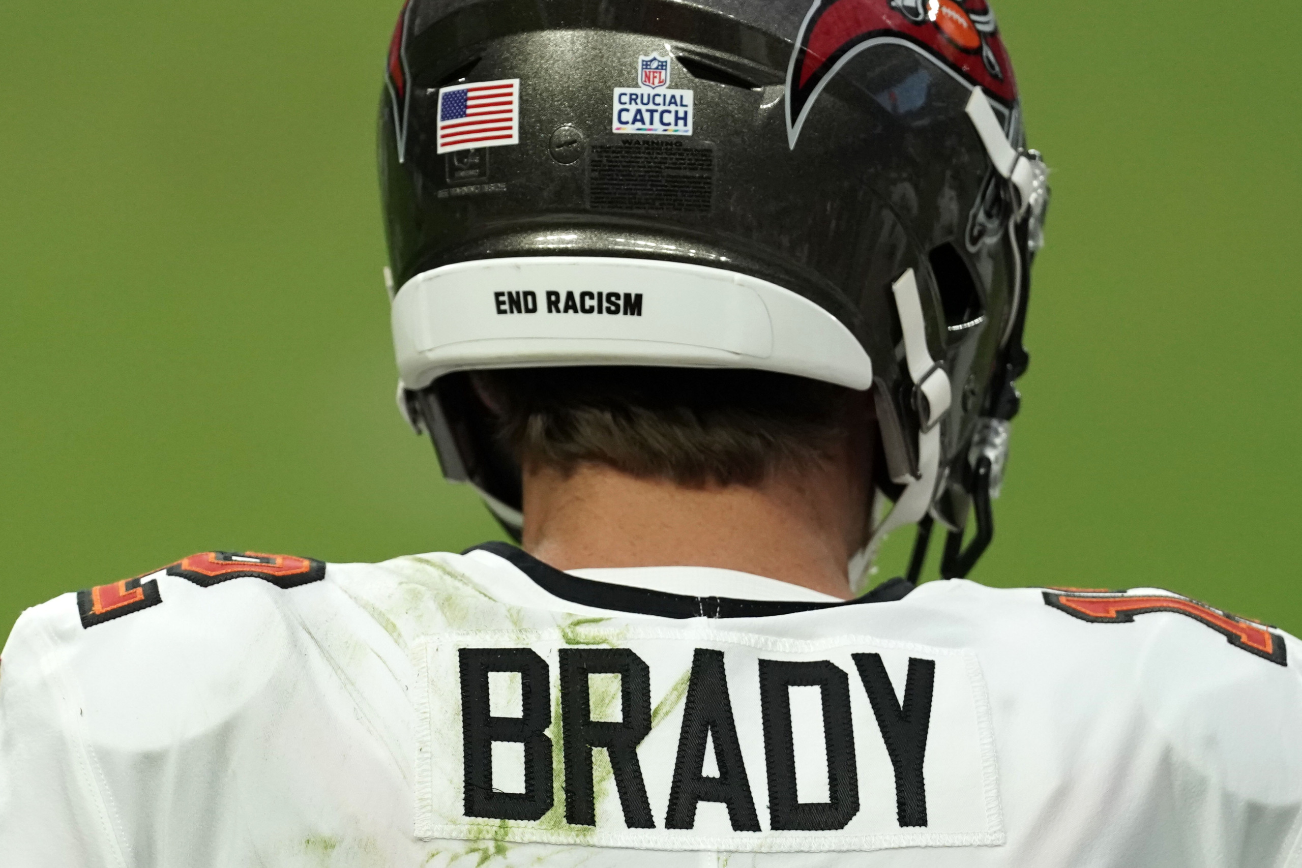 Why do NFL helmets have 'It Takes All of Us' written on them?