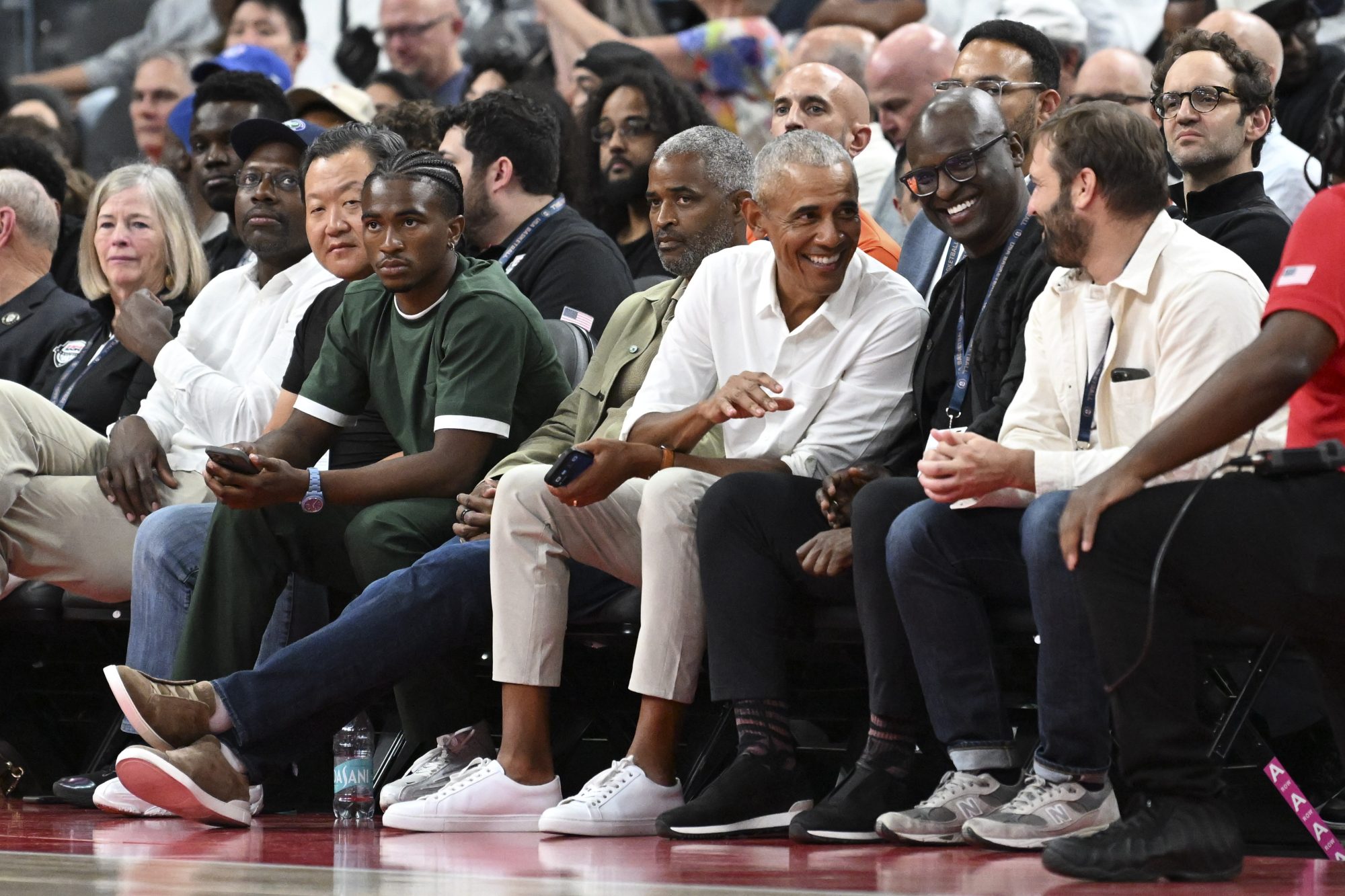 Jul 10, 2024; Las Vegas, Nevada, USA; Former President of the United States Barack Obama sits court side during fourth quarter of the game against Canada and USA for the USA Basketball Showcase at T-Mobile Arena.