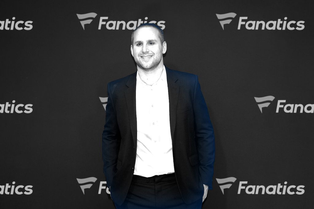 fanatics_logo_behind_man