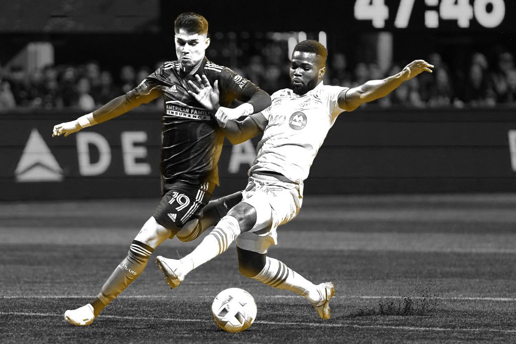two_men_playing_soccer