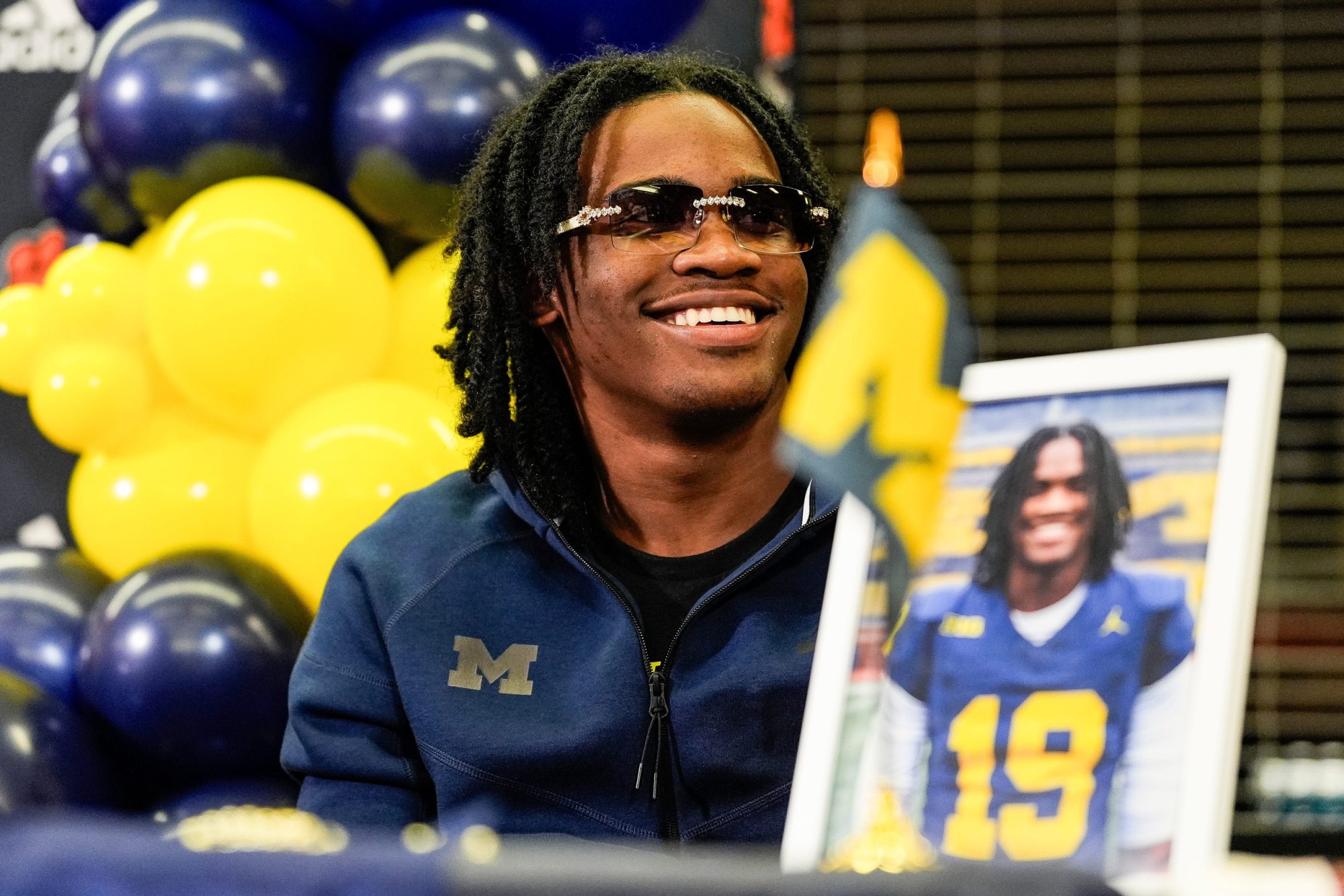 Michigan signee Bryce Underwood smiles during national signing day at Belleville High School in Belleville on Wednesday, Dec. 4, 2024.