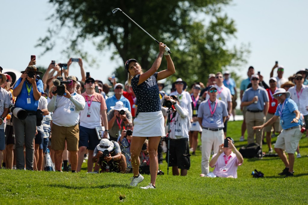 Woman-swings-club-in-front-of-crowd