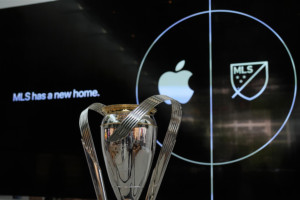 MLS Cup in front of advertisement for Apple as the new media partner for the league
