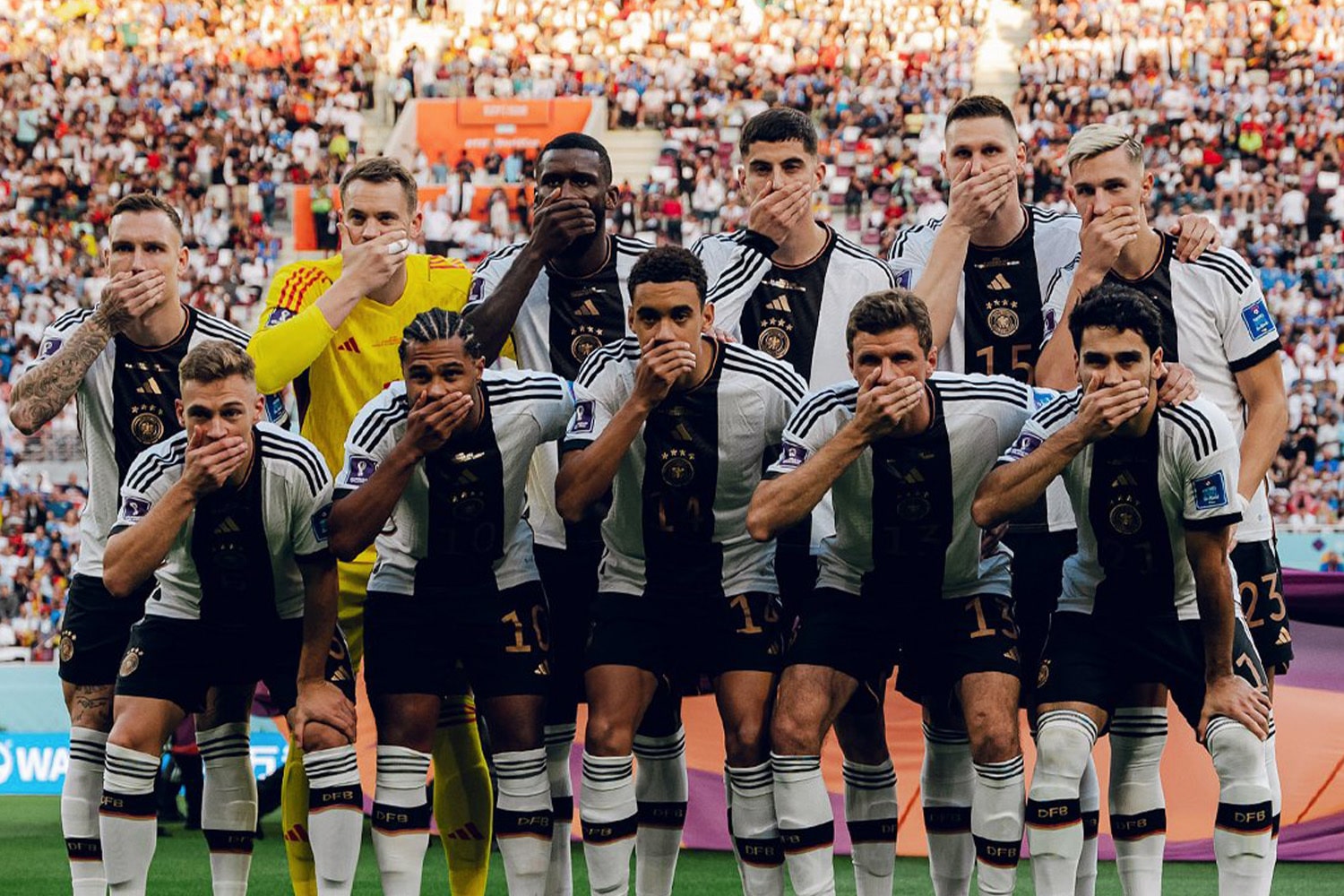 German national team use hands to cover their mouths in protest of FIFA sanctions ahead of World Cup in Qatar