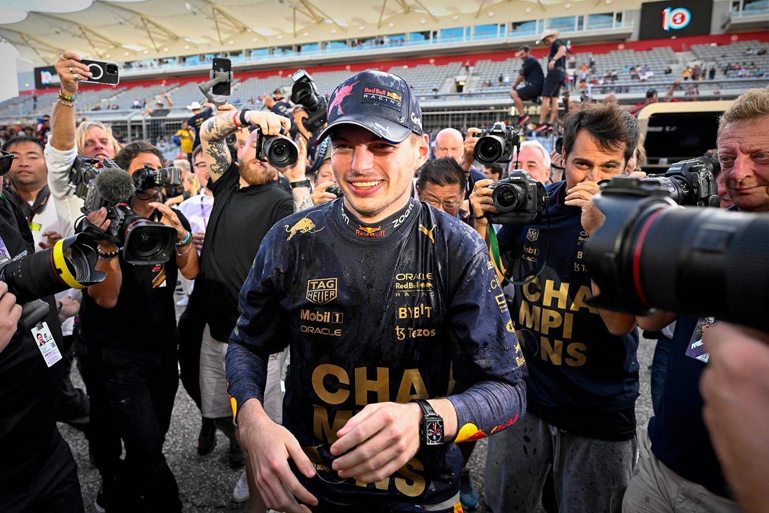 Max Verstappen surrounded by photographers after winning Formula 1 race