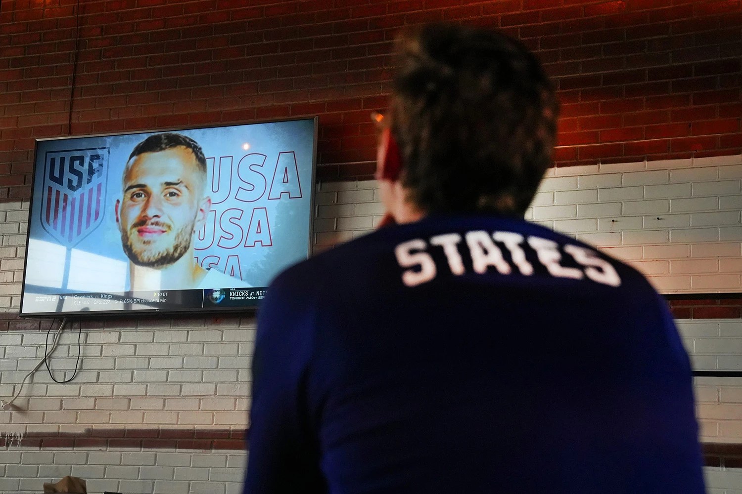 USMNT fan watches TV showing team roster
