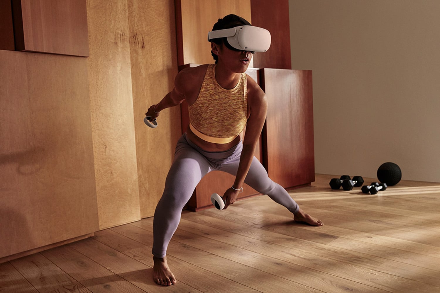Woman wears Meta Quest headset while working out to have virtual reality exercise session