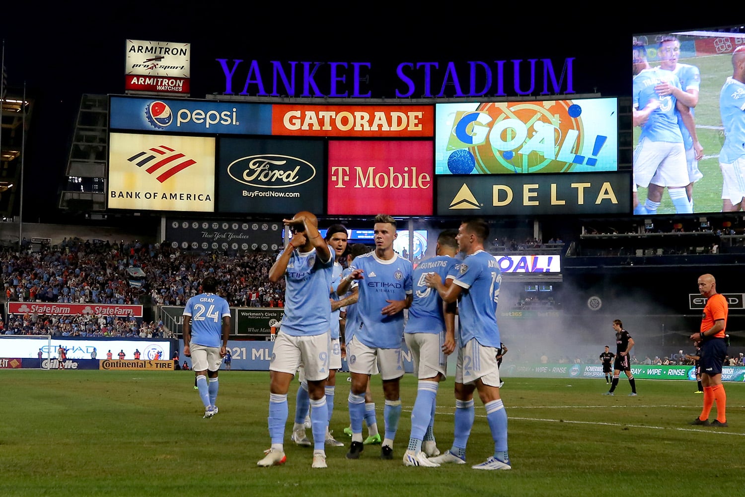 NYCFC players celebrate scoring a goal while playing in Yankees Stadium