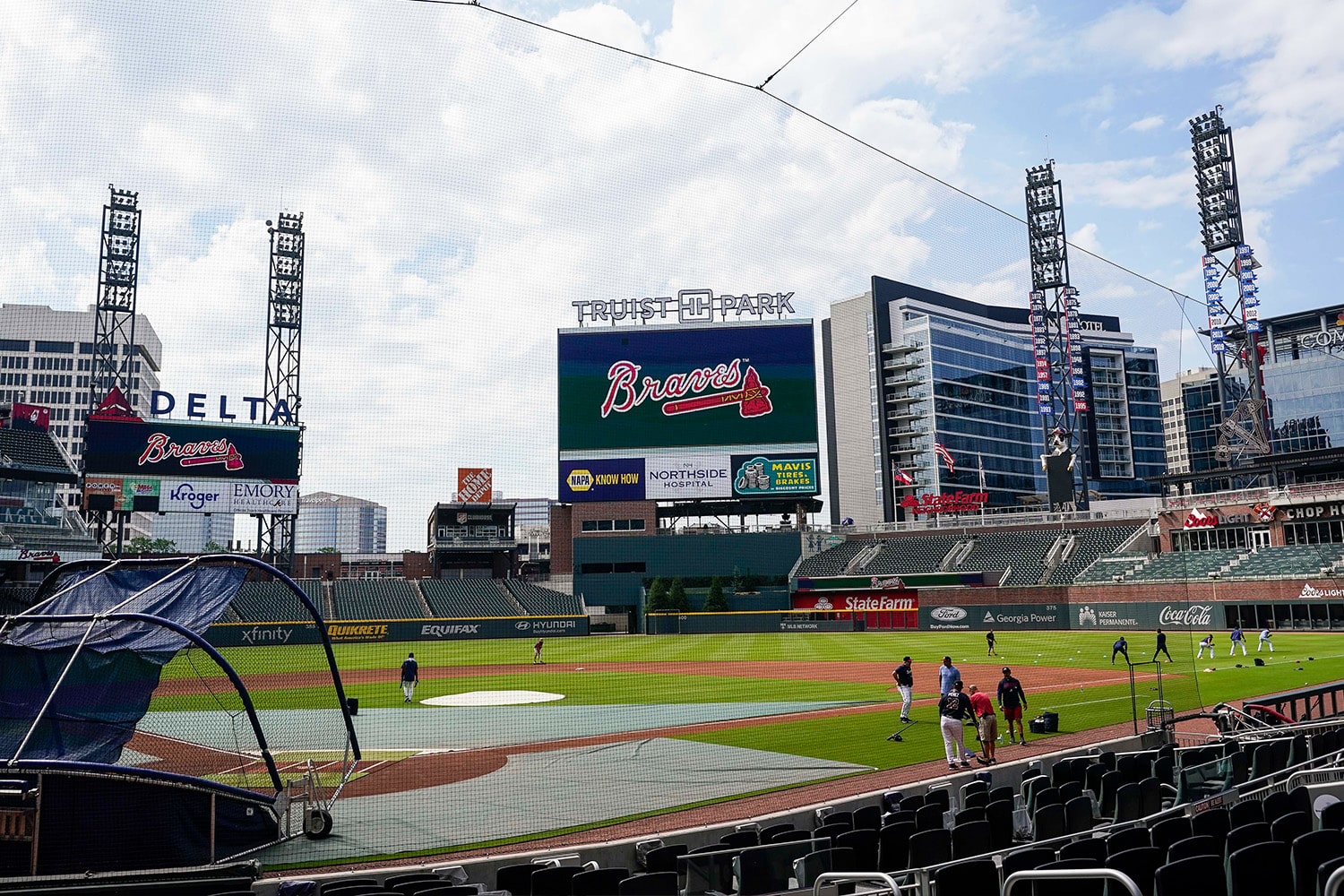 Players warm up on field inside of Atlanta Braves' Truist Park