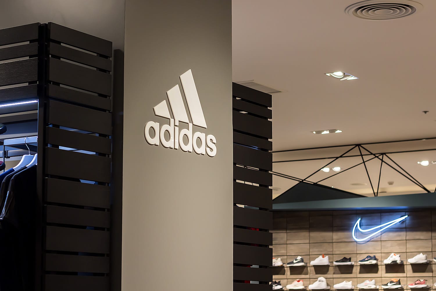 Adidas and Nike logos inside of sneaker store