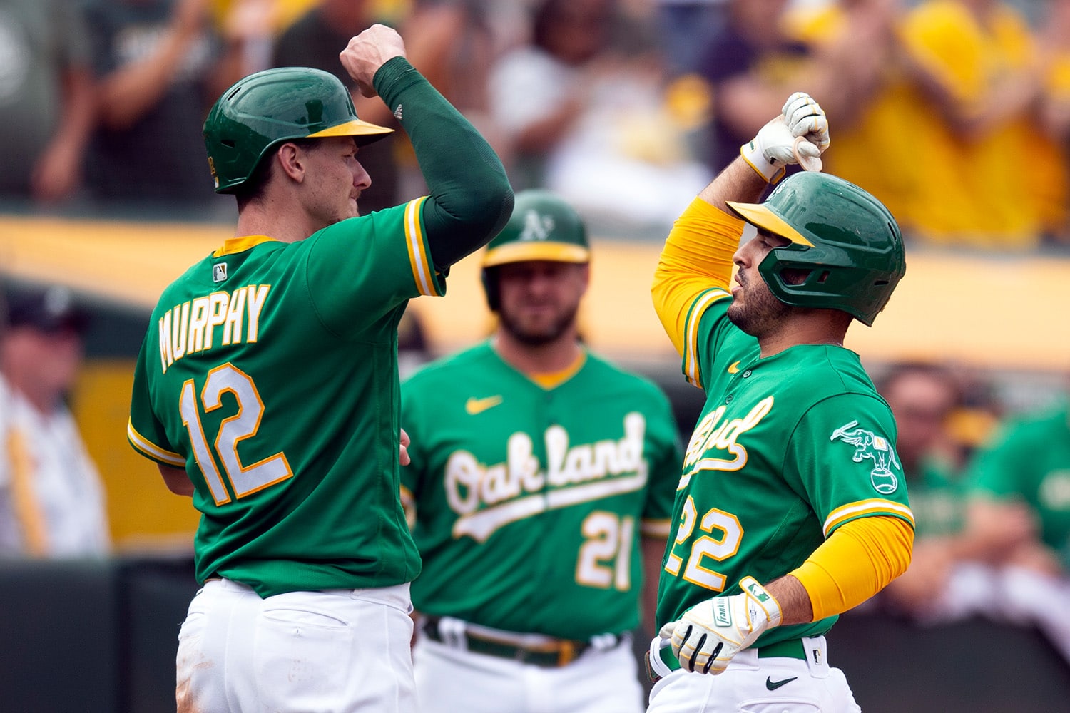 Oakland A's players Aledmys Diaz and Ramon Laureano celebrate after scoring a run