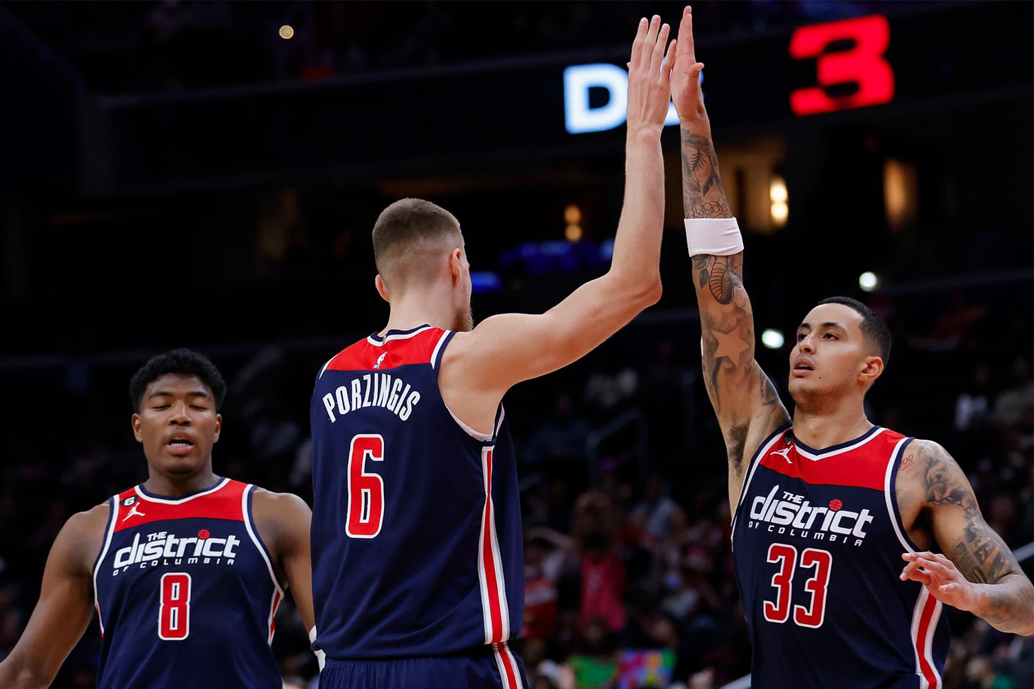 Washington Wizards players Kristaps Porzingis and Kyle Kuzma high-five during NBA game