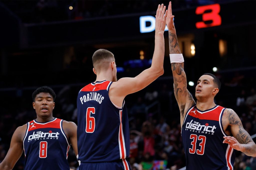 Washington Wizards players Kristaps Porzingis and Kyle Kuzma high-five during NBA game