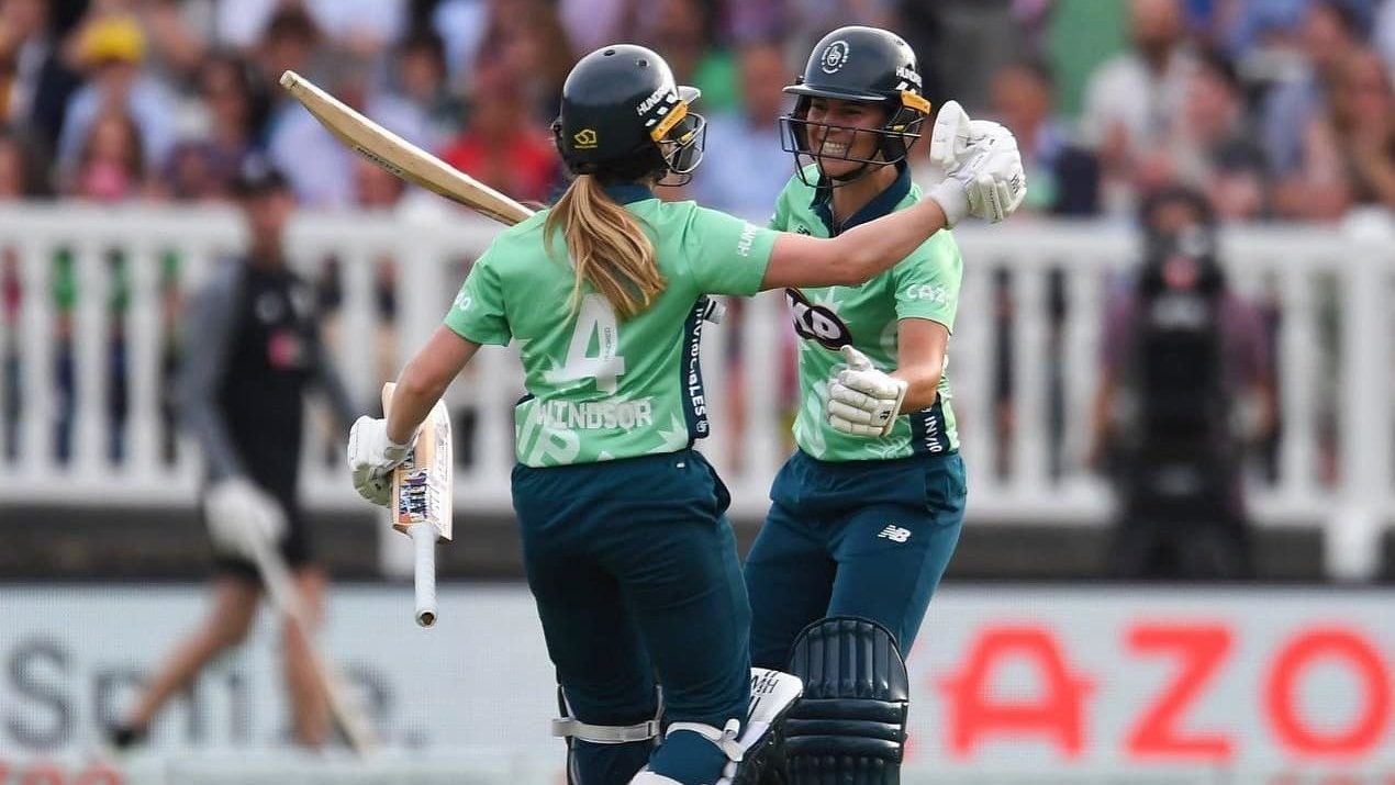 Teammates embrace during matchup in The Hundred cricket league