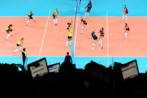 Player lines up for spike during women's indoor volleyball match