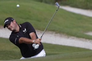 PGA tour player Patrick Reed chips ball onto green