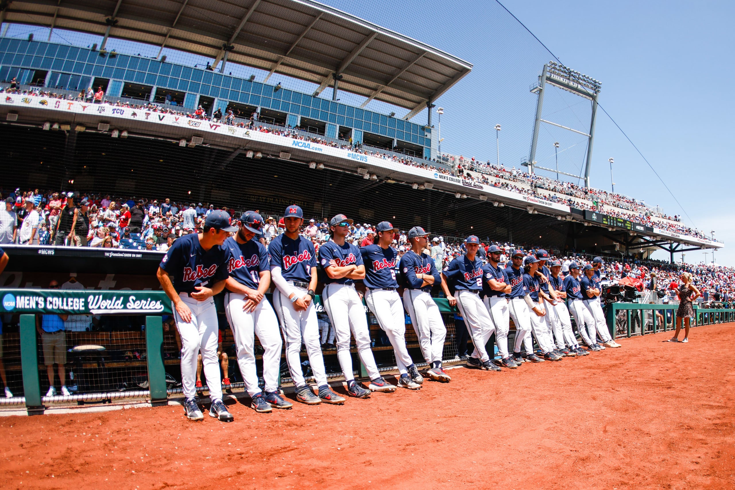 Ole Miss baseball players lean against dug-out during baseball College World Series in Omaha