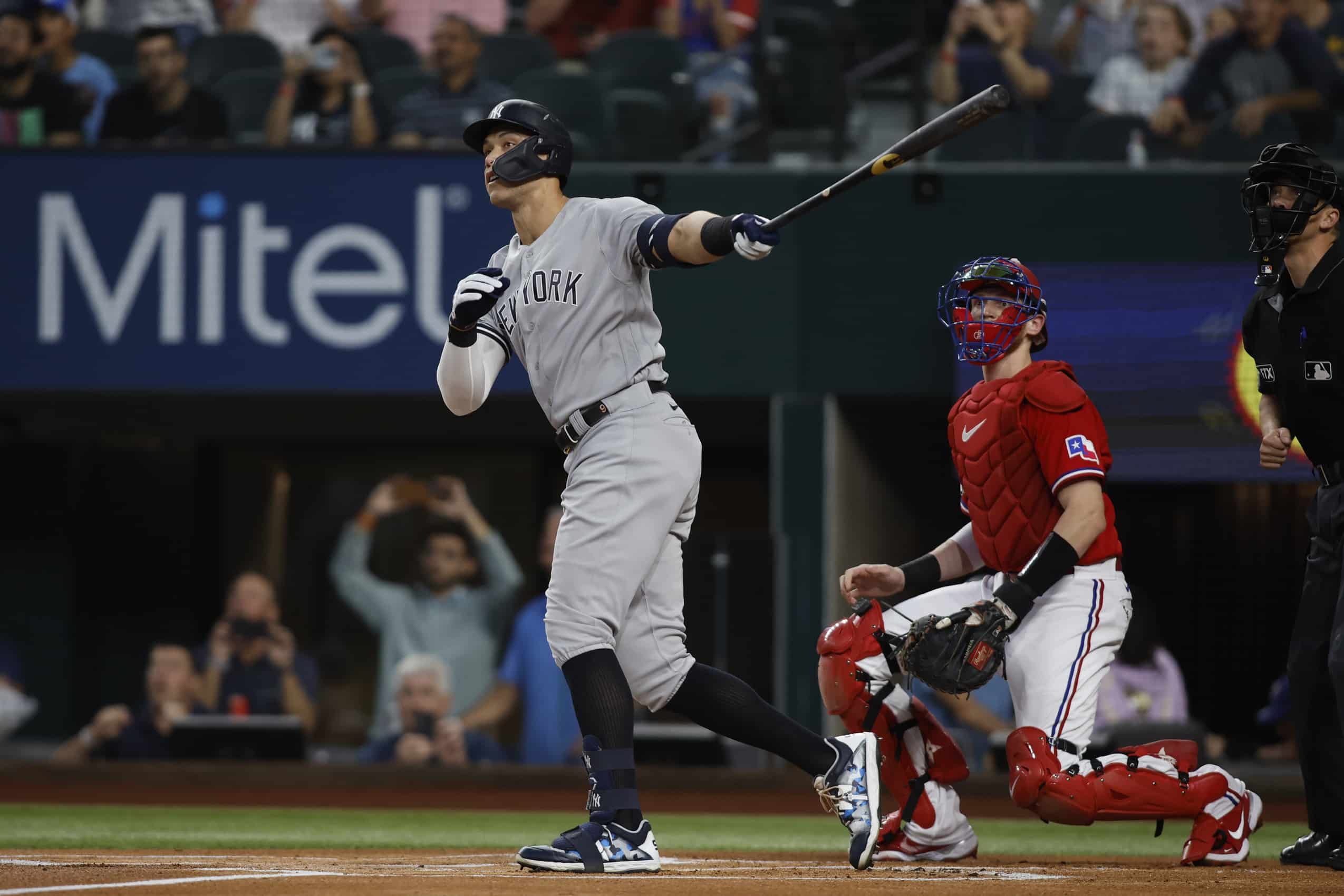 New York Yankees star player Aaron Judge and Texas Rangers catcher watch ball exit the park