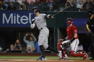 New York Yankees star player Aaron Judge and Texas Rangers catcher watch ball exit the park