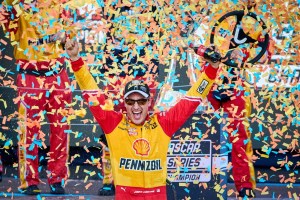 Joey Logano is surrounded by confetti after winning the NASCAR Cup Series championship 
