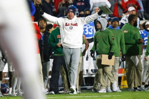 Ole Miss football head coach Lane Kiffin signals to players during college football game
