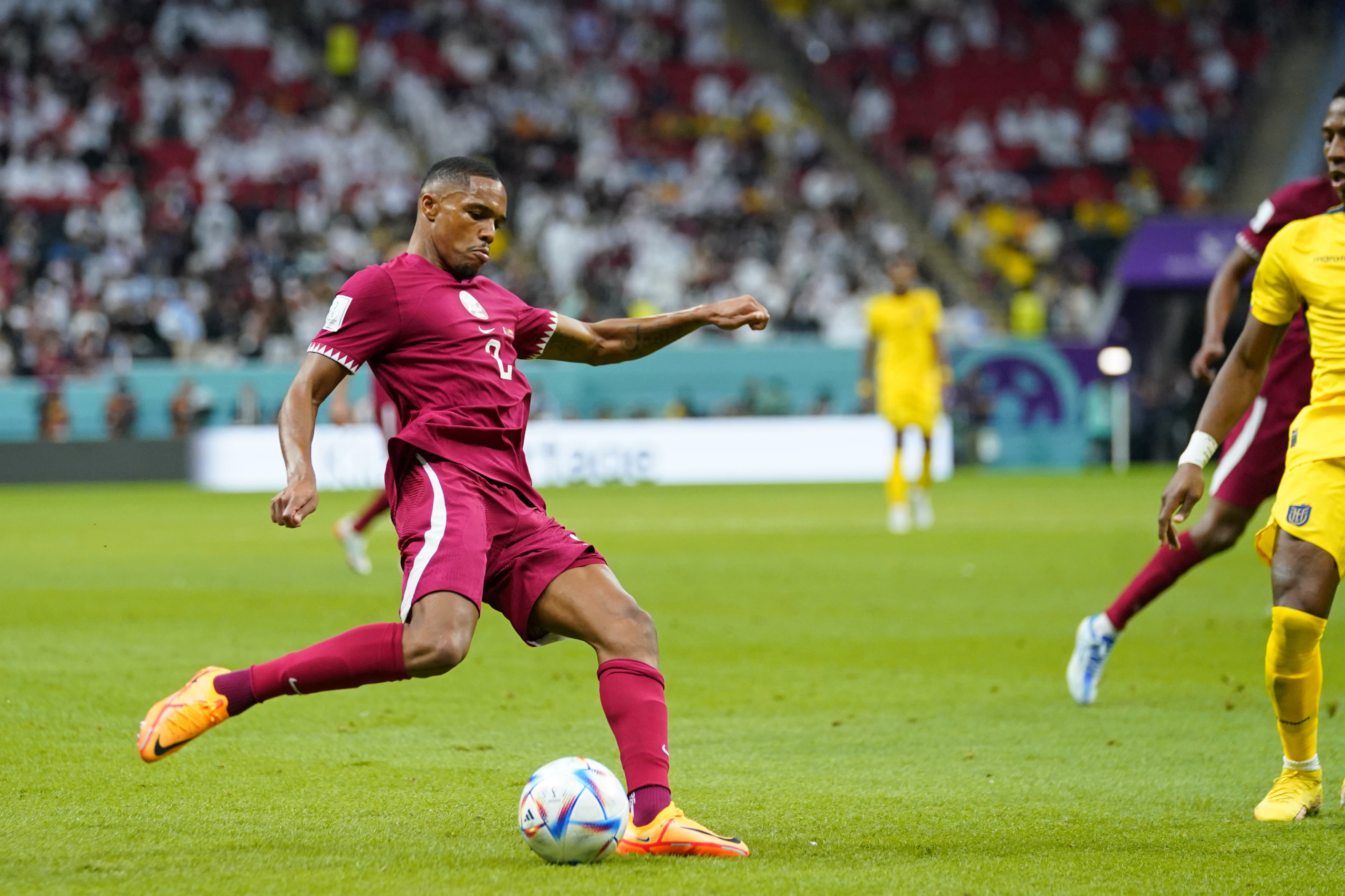 Qatar national team player attempts cross against Ecuador during World Cup match