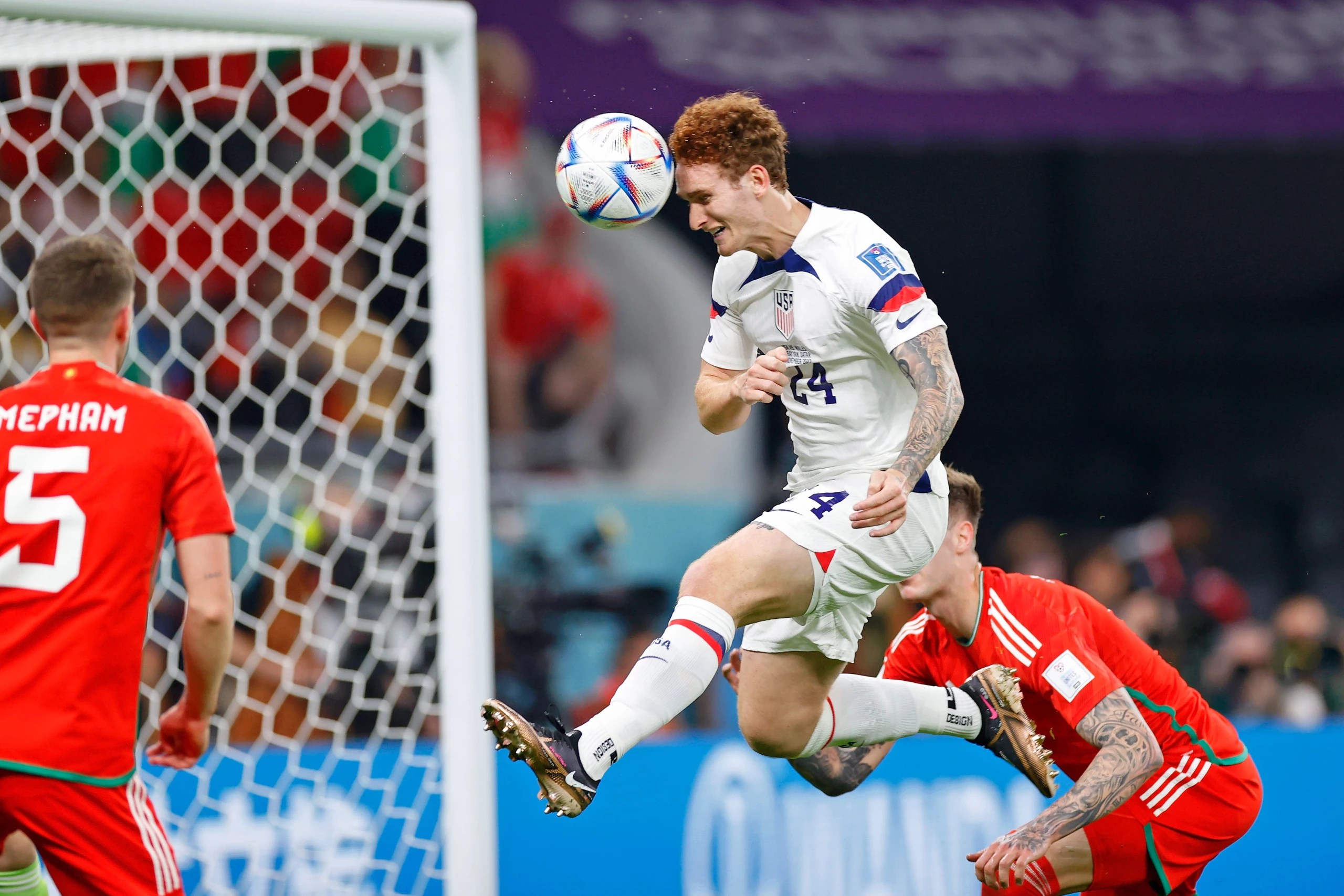 USMNT striker Josh Sargent heads ball towards Welsh goal during World Cup match