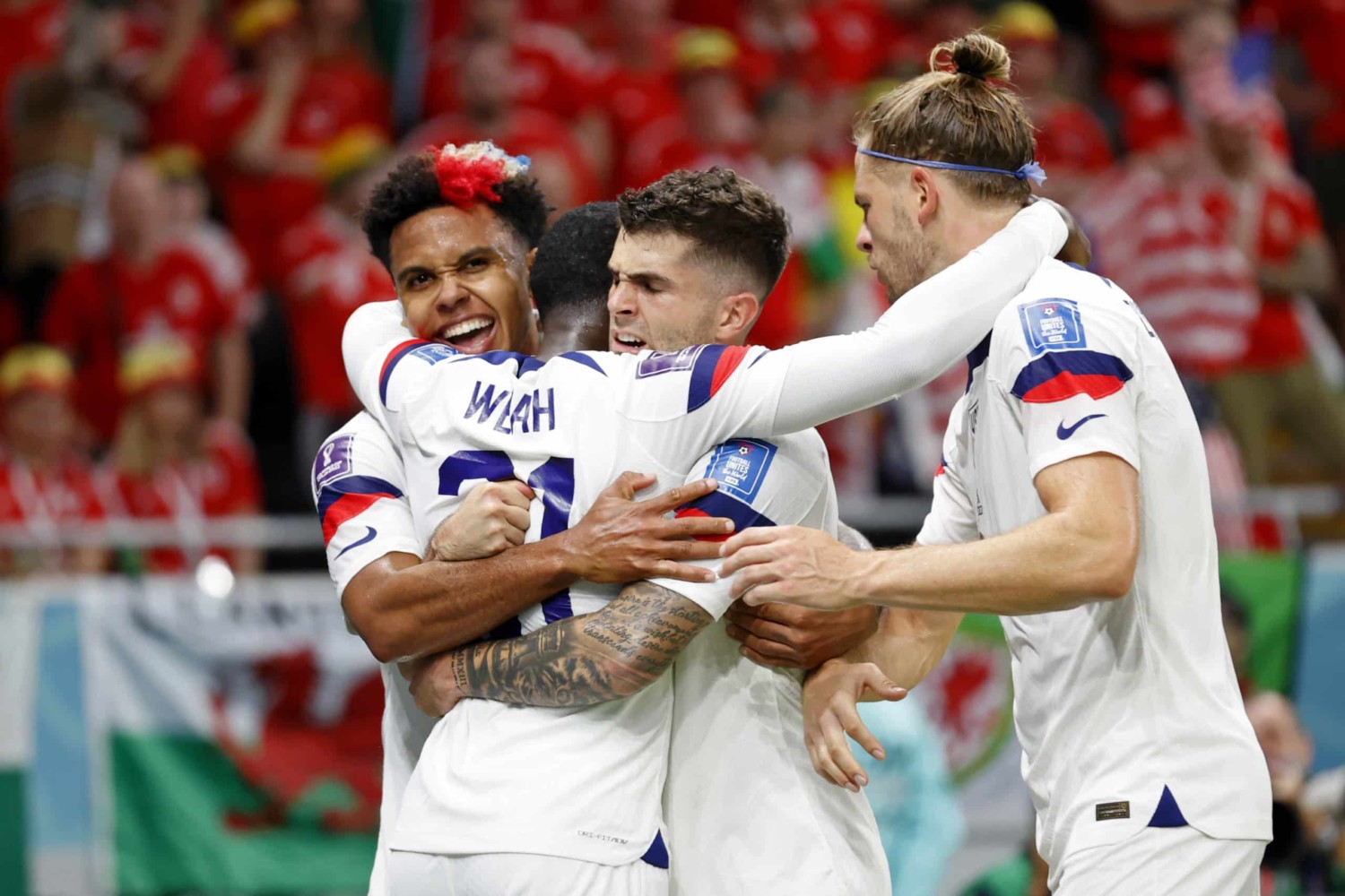 USMNT striker Timmothy Weah celebrates with teammates after scoring his first World Cup goal