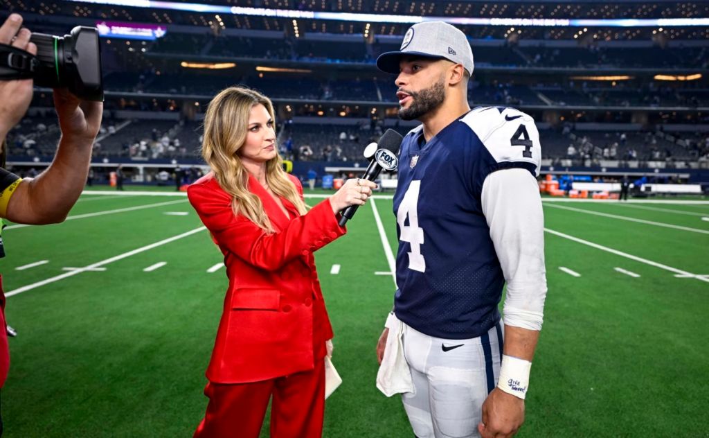 Fox sideline reporter Erin Andrews wearing bright red suit while interviewing Dallas Cowboys quarterback Dak Prescott after NFL game