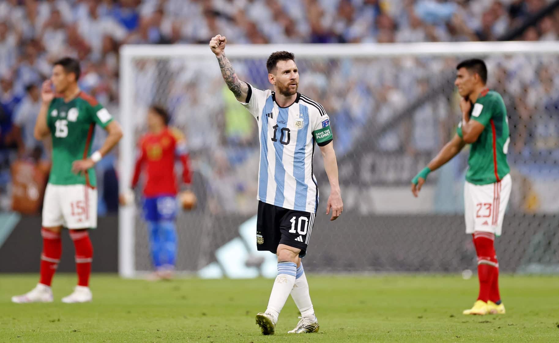 Messi raises fist in celebration during World Cup match against Mexico