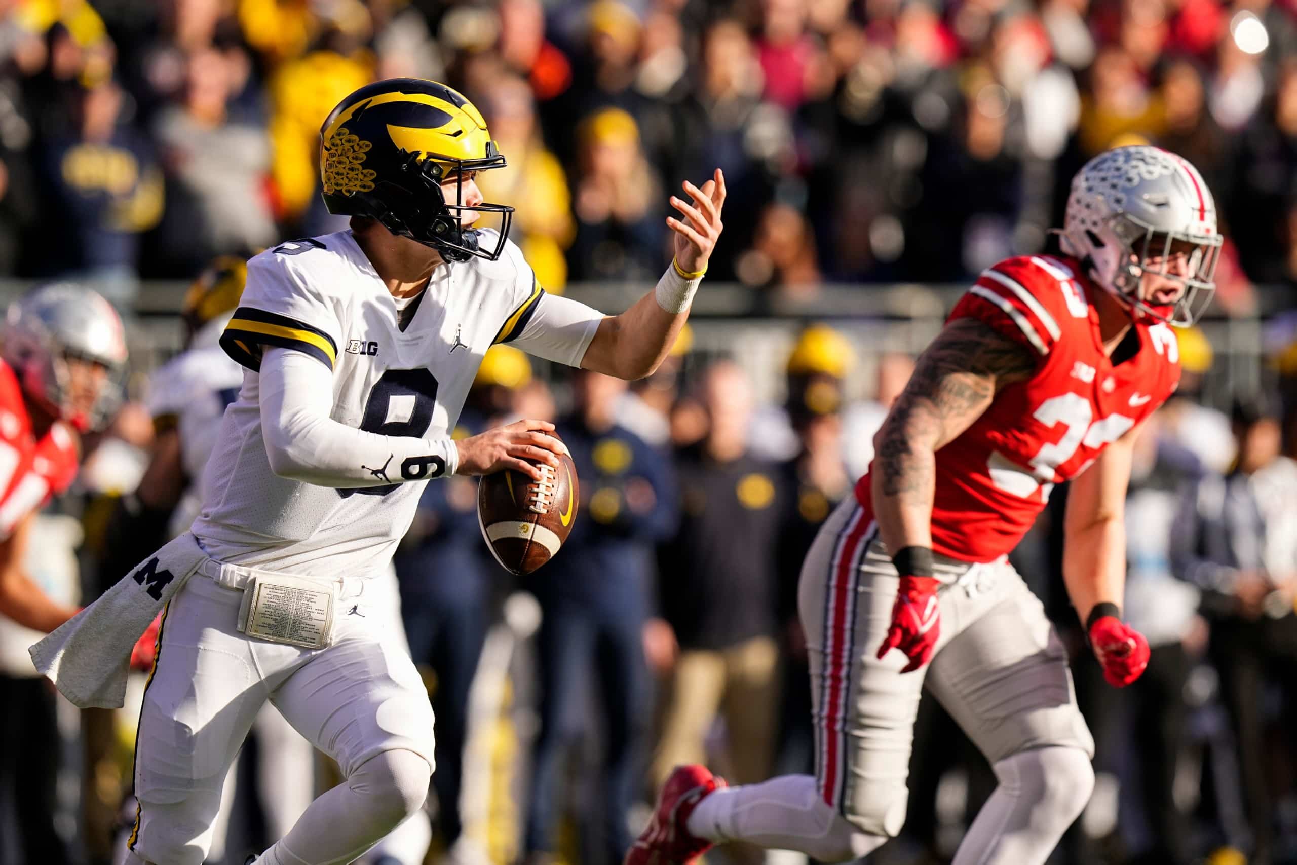 University of Michigan quarterback JJ McCarthy scrambles to complete pass against Ohio State