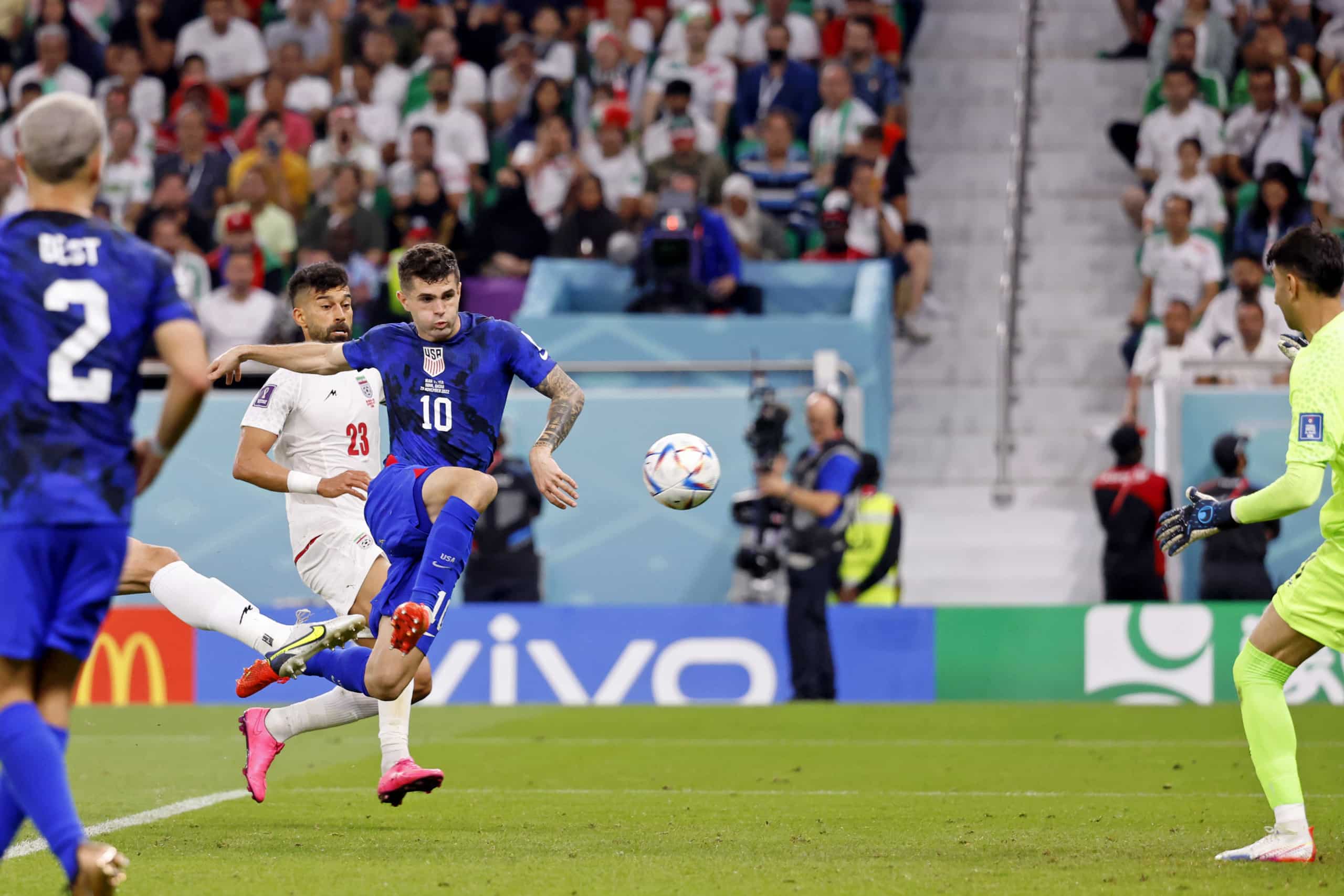 American soccer player Christian Pulisic scores volley past Iranian goal keeper in World Cup match up