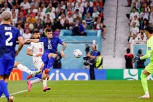 American soccer player Christian Pulisic scores volley past Iranian goal keeper in World Cup match up