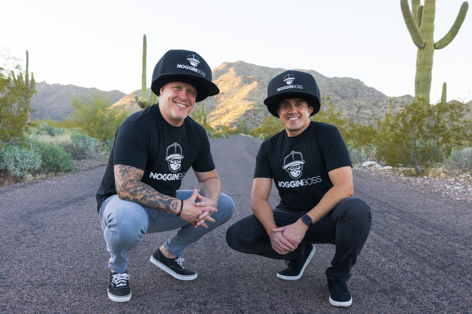 Founders of Noggin Boss Gabe Cooper and Sean Starner pose in large hats in front of desert back drop
