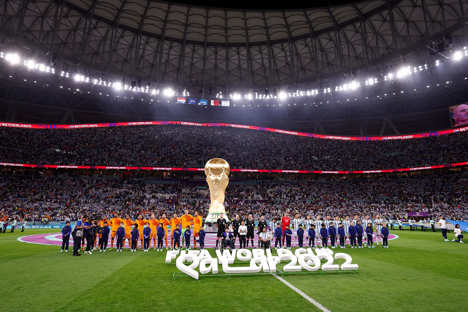 Netherlands and Argentina squads line up for photos before their World Cup match