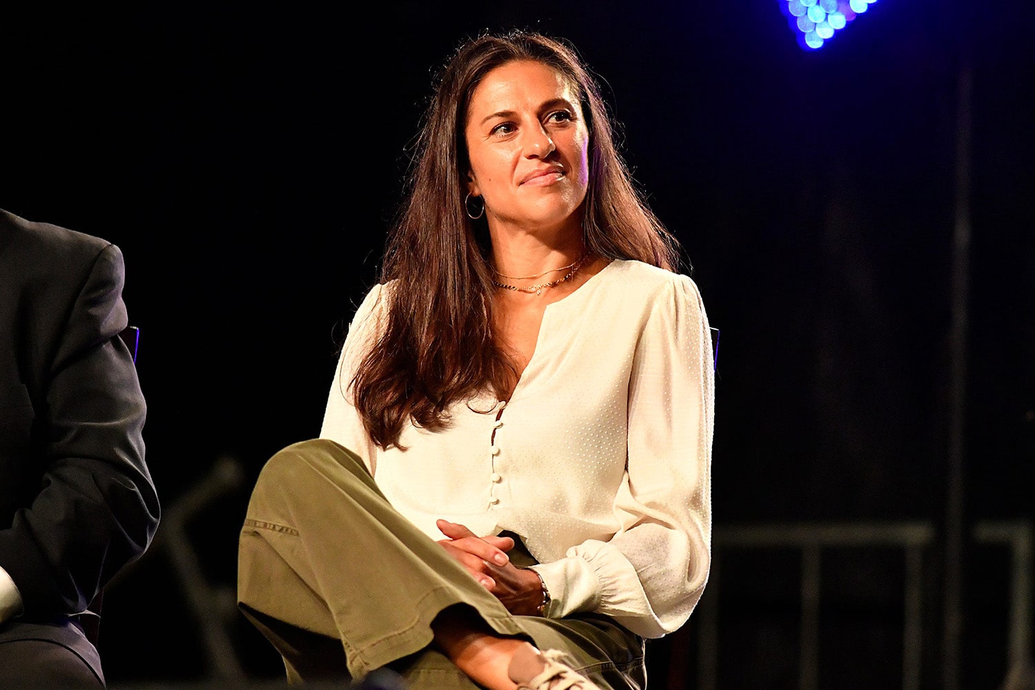 Former USWNT player Carli Lloyd sitting on stage and answering questions