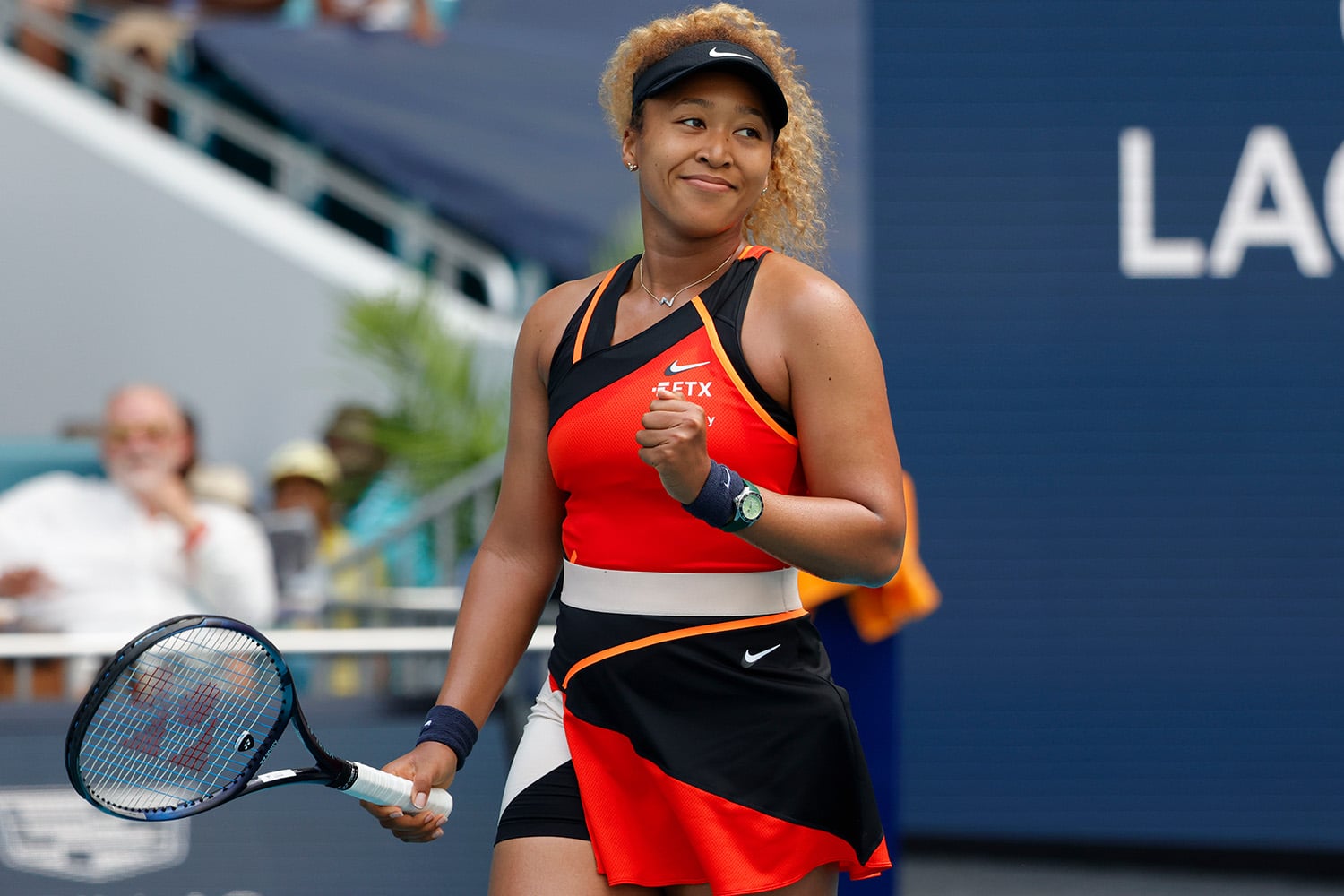 Naomi Osaka pumps fist and smiles after winning a point