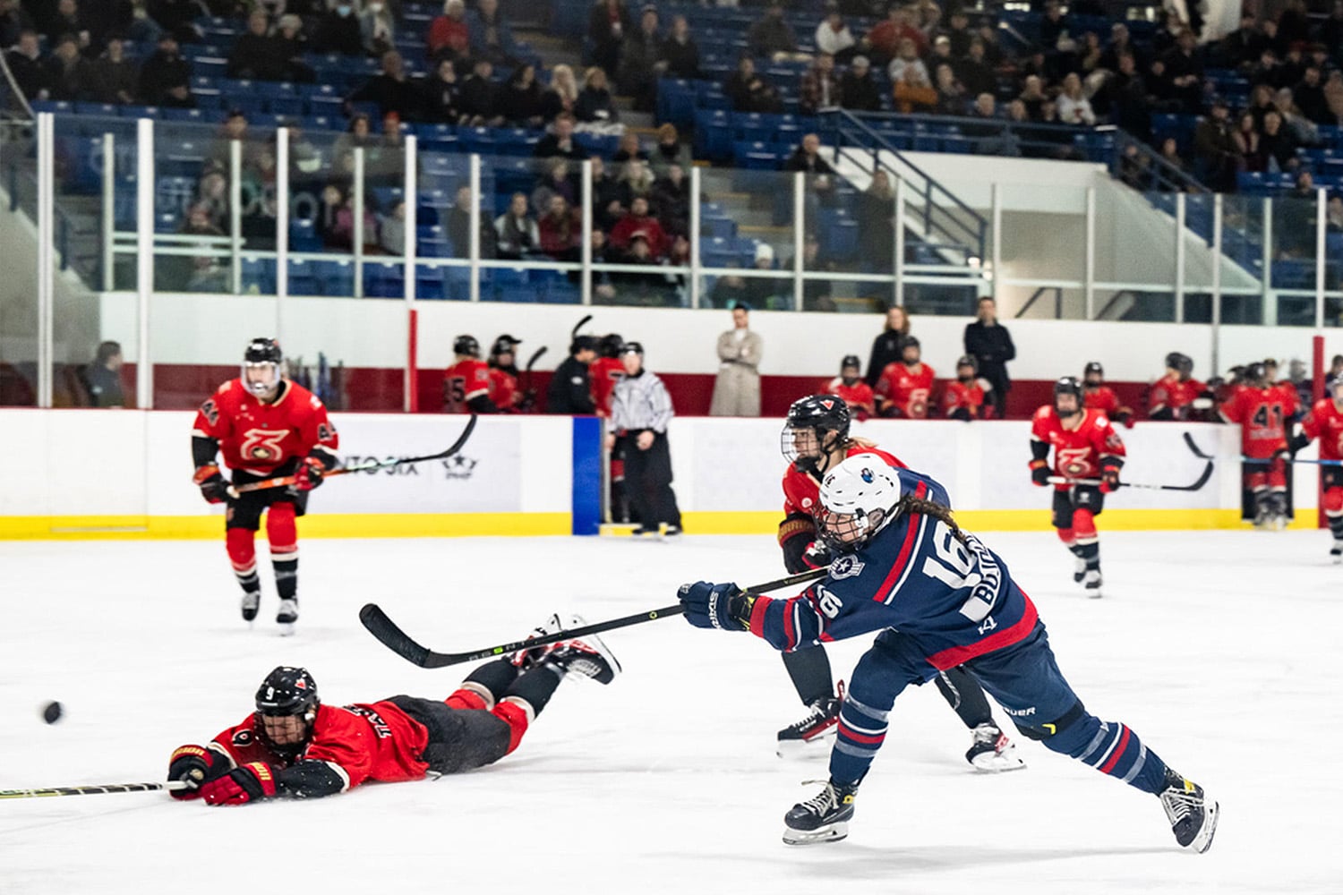 Woman attempts shot during Premiere Hockey Federation matchup