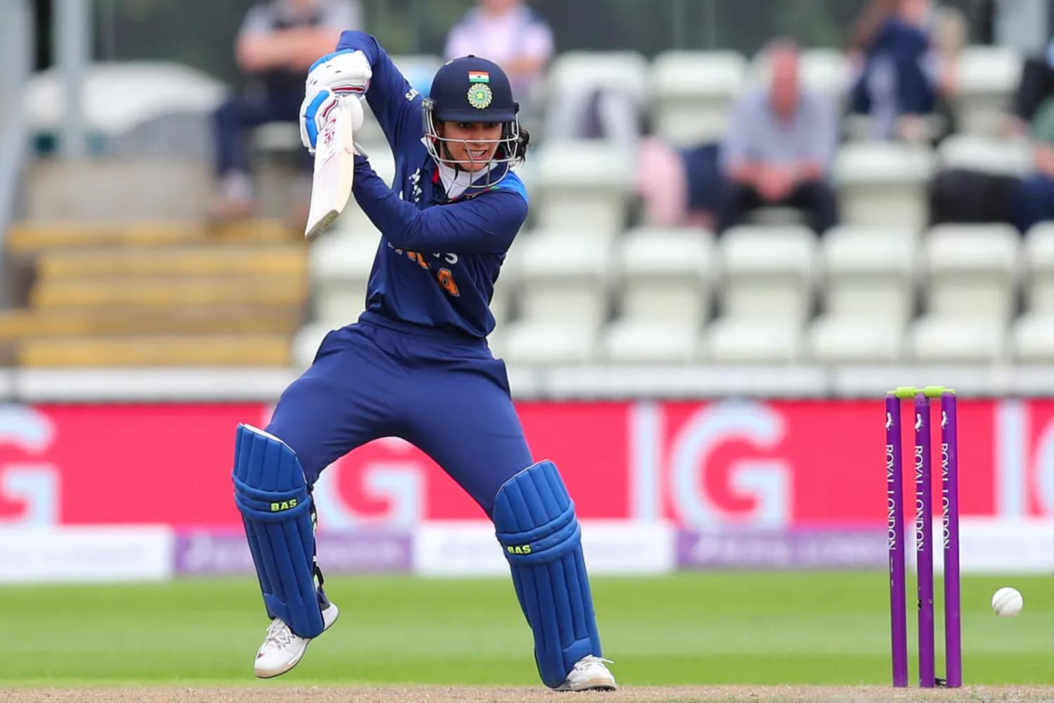 Female cricket player batting