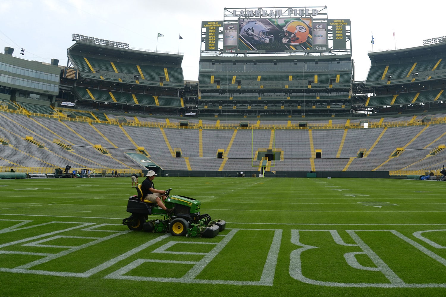 Man cuts grass on Lambeau Field before the Packers match up with the Raiders