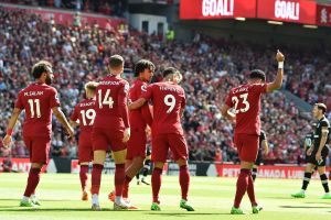 Liverpool players celebrate after scoring a goal