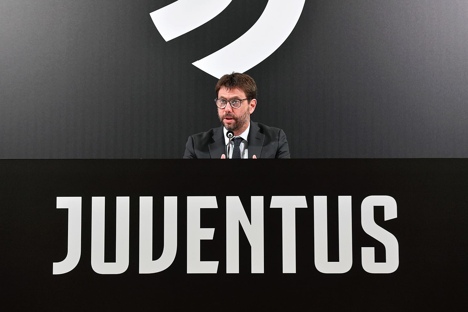 Former Juventus chairman Andrea Agnelli talking to media in front of team logo