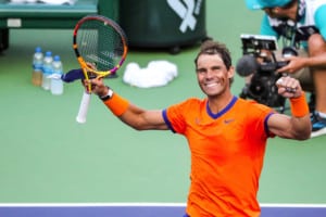 Rafael Nadal smiles and pumps fists after winning match